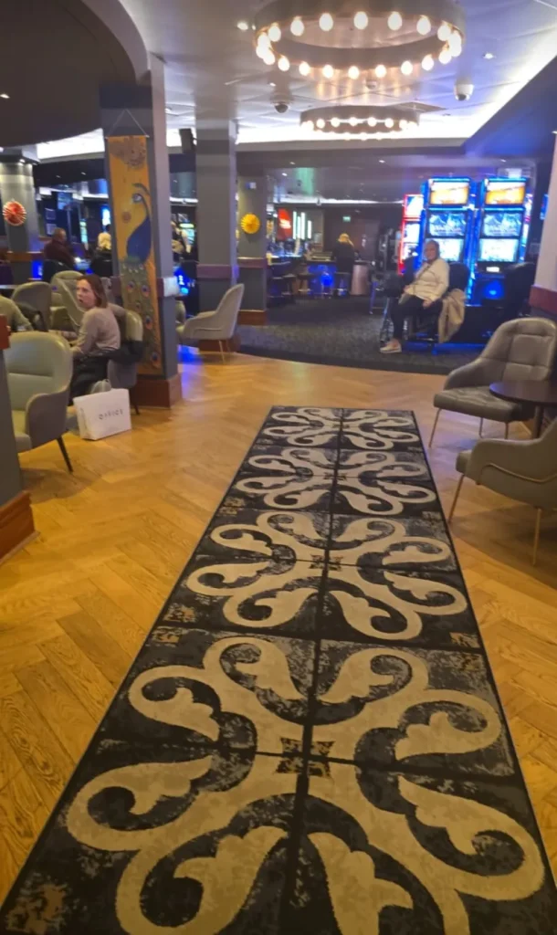 Lounge seating and slot machines inside Grosvenor Casino Bristol