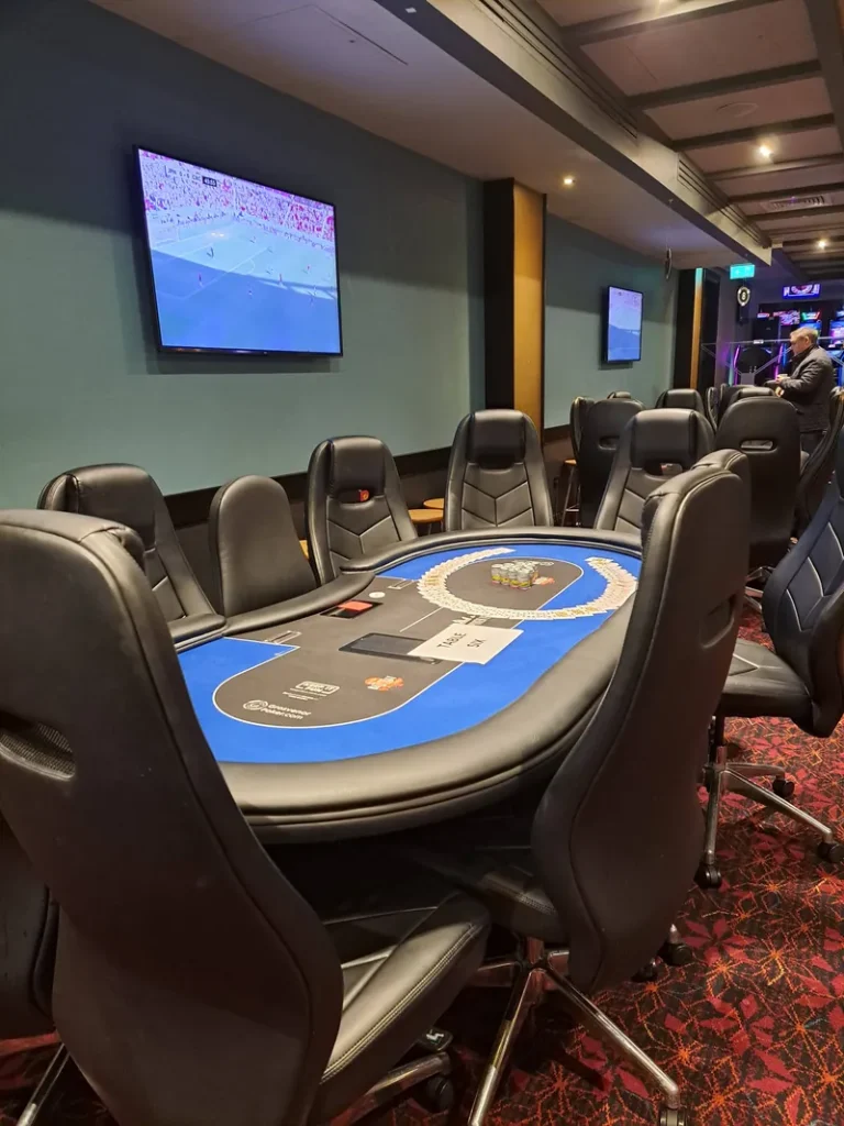 Poker table with sports screens at Grosvenor Casino Leeds Westgate