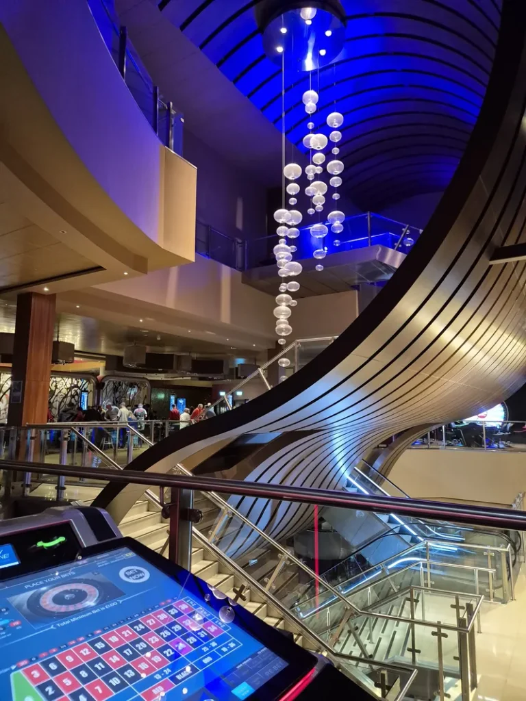 Alea Casino Glasgow atrium with staircase and blue lighting