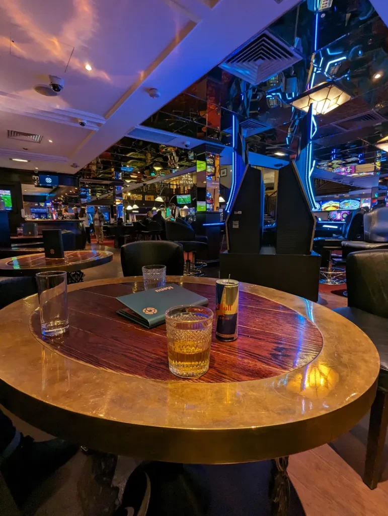 Casino lounge area with drinks and blue lighting