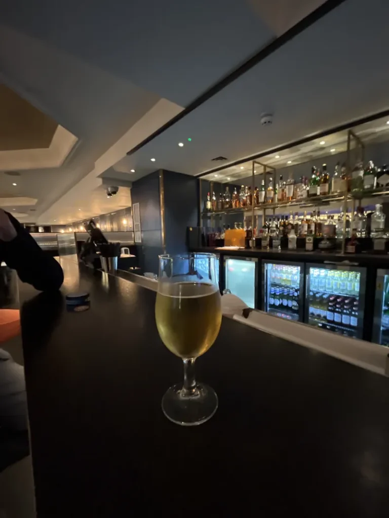 Barracuda casino bar with drink and illuminated bottle shelves