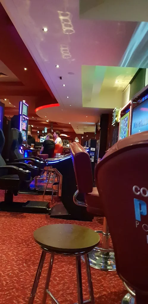 Slot machines and red seating inside Grosvenor Casino Plymouth