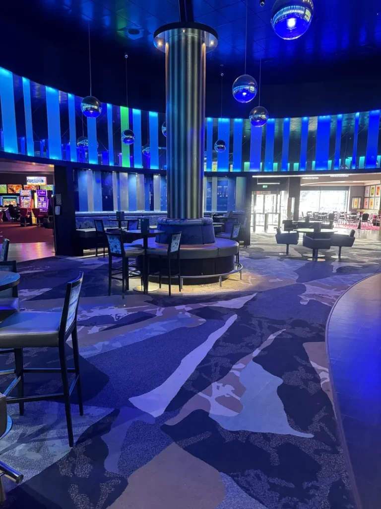 Blue-lit lounge area inside Grosvenor Casino Reading South