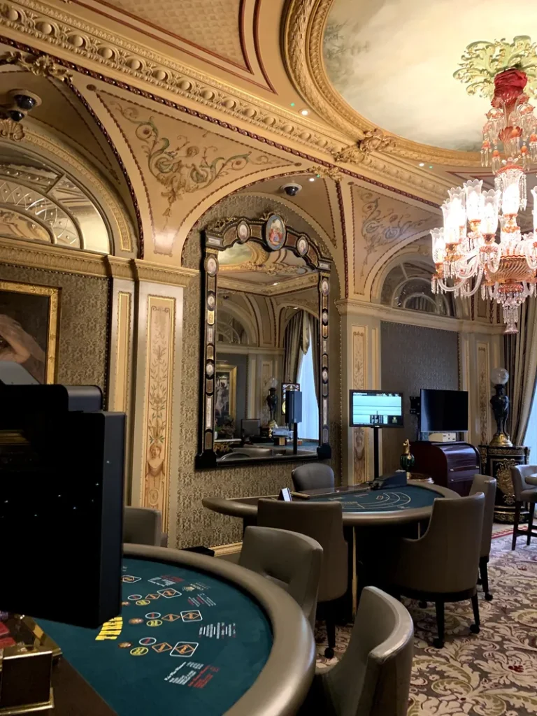 Casino tables beneath an ornate ceiling at Wynn Mayfair